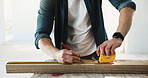Carpenter, hands and tape measure on wood for design, creative project and quality assurance. Man, tools and marker with timber for woodworking, accurate dimensions and material prep for drawing line