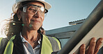 PPE, woman or engineer at construction site with tablet, smile or renovation project pass inspection. Low angle, mature person and happy outdoor with tech, engineering safety standard and compliance.