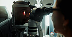 Optometry, patient and slit lamp for eye exam, retina check or diagnostic for structural health. Vision, optometrist or man with light in dark clinic for glaucoma test, iris assessment or healthcare