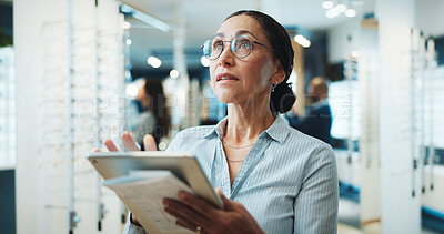 Buy stock photo Optometry, stock and woman on tablet for store inventory, inspection and online checklist for frames. Shop, mature and person on digital tech with prescription lens, spectacles and glasses for vision