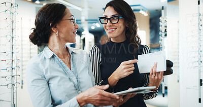 Buy stock photo Optometry, tablet and vision with women in store for  consulting, glasses advice and discussion. Lens fitting, online prescription and eye care with client and optometrist in clinic for ophthalmology