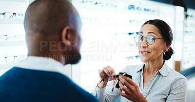 Buy stock photo Man, customer and optometry with glasses in store for eye test, frame recommendation or suggestion. Male person, woman or optometrist with spectacles or lens for vision, sight or assistance in shop