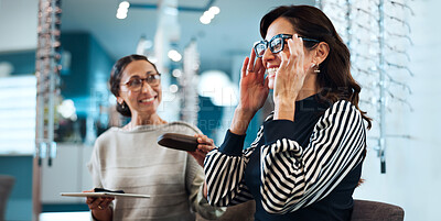 Buy stock photo Woman, optometrist or glasses with customer for recommendation, suggestion or frame choice. Female person, sales representative or smile in optometry shop with spectacles for vision or eyesight