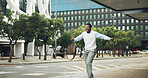 Excited, travel and black man dancing in city with bag for winning, celebration or outdoor trip. Happy, businessman and smile with energy on sidewalk for vibe, victory or achievement in an urban town
