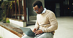 Business, black man and typing in city with laptop, research and valuation report for real estate. Male person, realtor and review in town with pc, pricing property and bidding comparison for auction