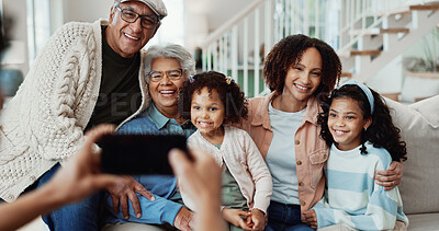 Buy stock photo Happy, phone and picture with big family in home for bonding holiday, weekend visit or memory. Grandparents, parent or smile with children for capture moment, generation or photography in house