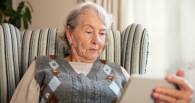 Buy stock photo Tablet, reading and elderly woman on chair for online news, ebook or internet browsing. Retirement, old person or relax with digital tech in home for streaming subscription, puzzle or social media