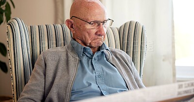 Buy stock photo Reading, newspaper and article with elderly man in living room of home for break or information. Relax, glasses and retirement with old person on chair in apartment for media publication or report