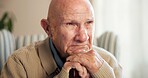 Thinking, sad and senior man in home for nostalgia, sadness and lonely with grief in retirement. House, walking stick and elderly person with depression, worry and thoughtful for memory, past or loss