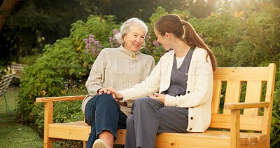 Buy stock photo Caregiver, bench and senior woman in garden with smile, conversation or elderly care at nursing home. Happy, nurse and old person in backyard for retirement, friendly chat or support for homecare