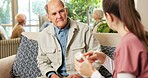 Senior, man and nurse with pills in retirement home for medication or pharmaceutical advice. Elderly, male person or caregiver talking to patient with tablets for medical help, cure or treatment
