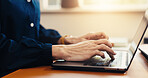 Typing, online and hands with laptop in office, accountant and tax preparation with info on website. Bookkeeper, research and person with technology, budget review and financial report in business