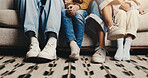 Feet, sofa and family together in home, love and bonding with connection, relax and relationship. People, parents and children with legs, couch and comfortable with chill, break and weekend at house