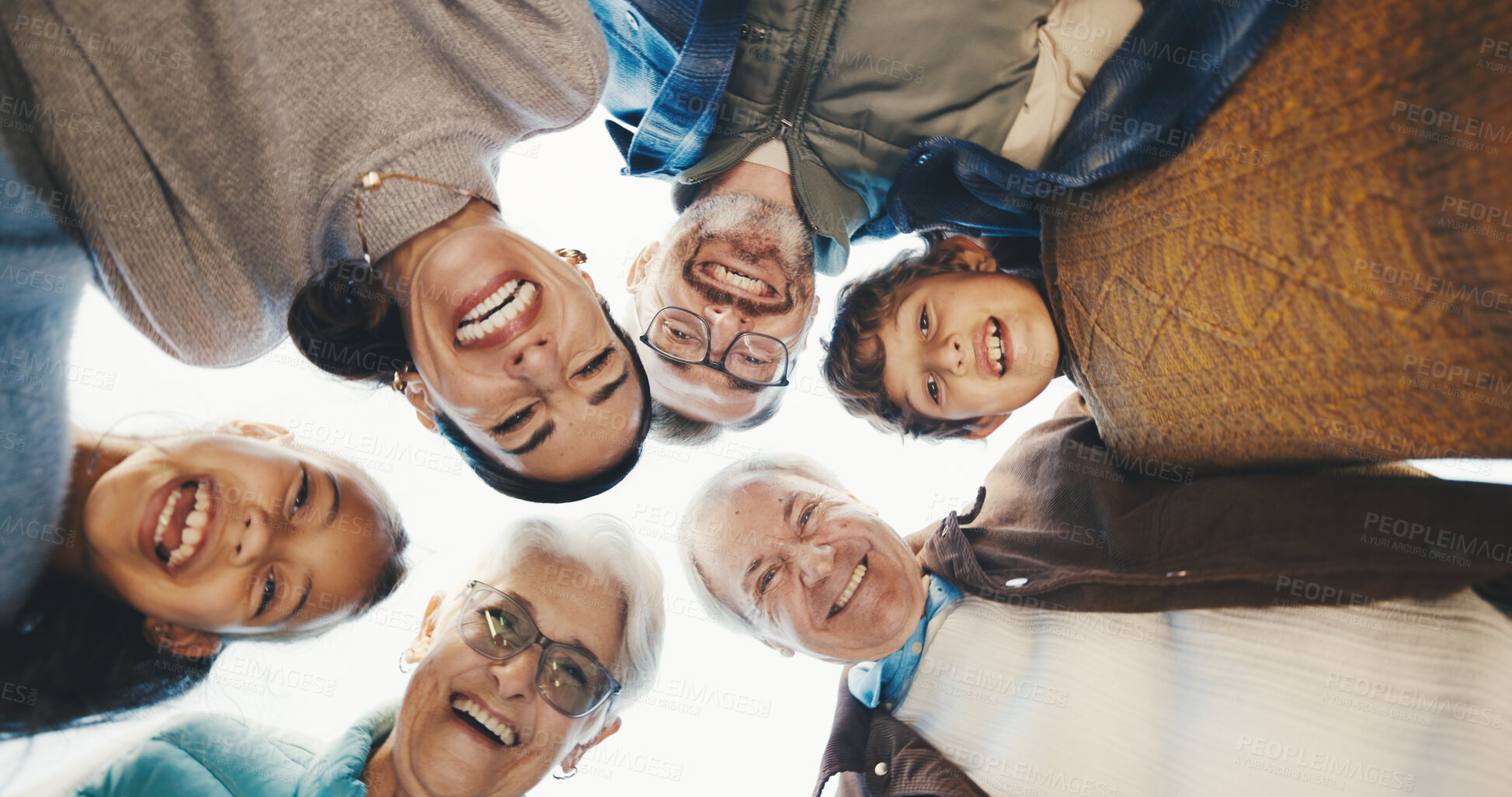 Buy stock photo Below, portrait and big family in huddle outdoor with bonding, love and connection on holiday. Happy, care and children with parents and grandparents in circle for support and safety on vacation