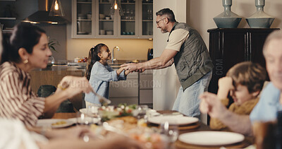 Buy stock photo Big family, dinner and father with girl for dance, bonding and playful together in home. Holding hands, smile and dad with daughter for fun and support with love, music and help with development