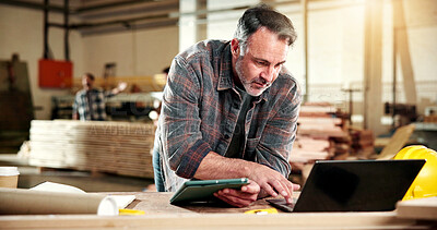 Buy stock photo Carpenter, research and man with tech in workshop, online and searching for furniture design on web. Warehouse, artisan and mature person with laptop, typing and planning for woodworking project