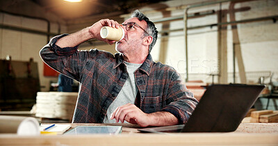 Buy stock photo Coffee, carpenter and laptop with man in warehouse for construction plan, research or design software. Furniture manufacturing, online project and woodworking with mature person in workshop for drink