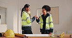 Architect, team and fist bump in building with smile, design agreement or property development goals. Happy, women and celebration on job site with architecture success, partnership and achievement.