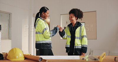 Buy stock photo Architect, team and fist bump in building with smile, design agreement or property development goals. Happy, women and celebration on job site with architecture success, partnership and achievement.