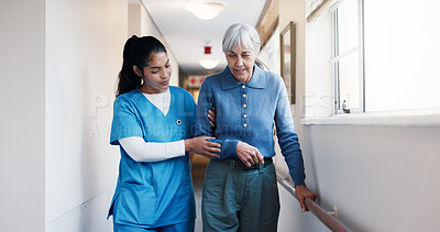 Buy stock photo Caregiver, help and walking at facility with old woman, support and mobility aid for injury recovery. Nurse, guide or person with disability, gait training and balance assistance for physical therapy