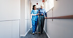 Caregiver, helping and walk at facility with old woman, support and mobility aid for injury recovery. Nurse, guide or person with disability, gait training and balance assistance for physical therapy