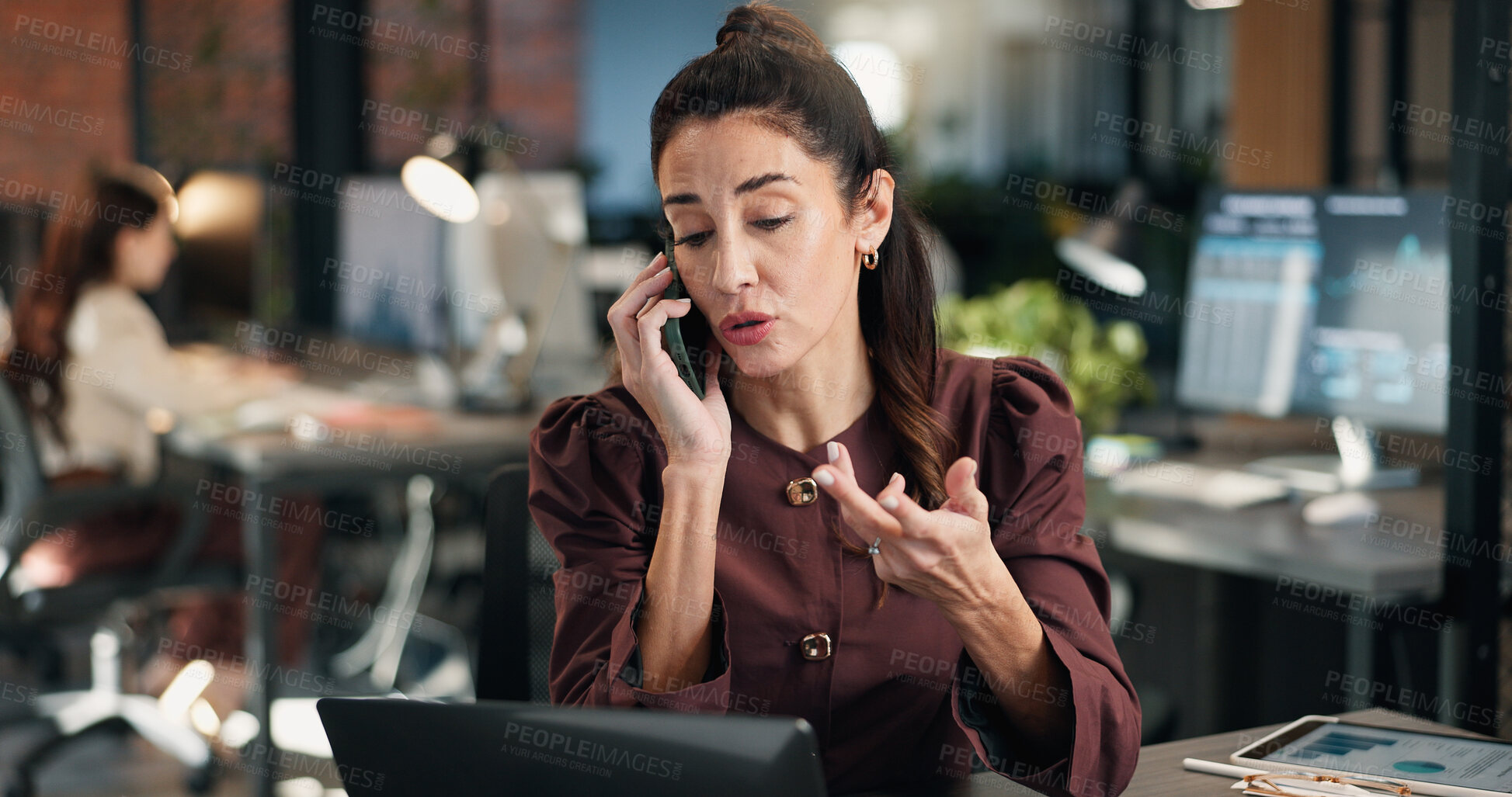 Buy stock photo Laptop, woman and phone call in office for data analysis, financial report and advice at night. Coworking, tech and mature person talking to contact for investment graphs, communication and overtime