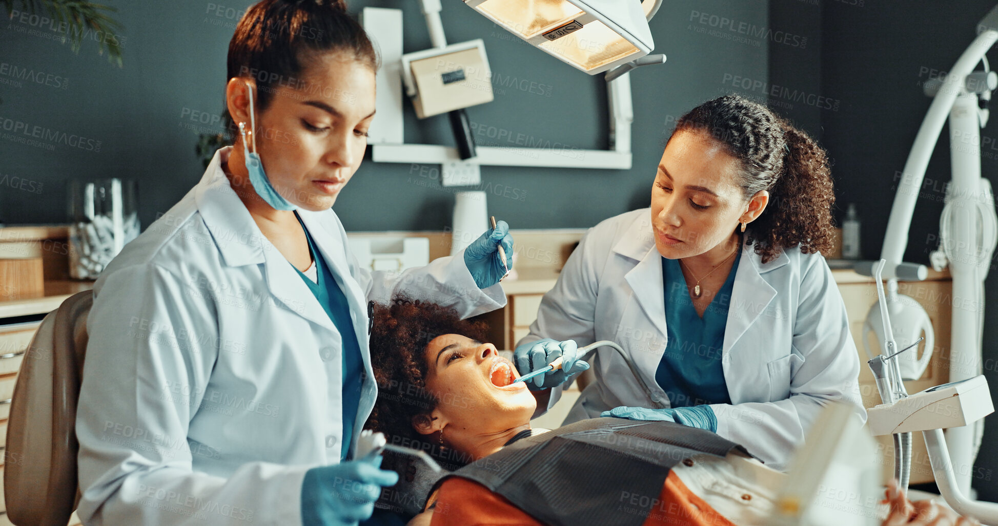 Buy stock photo Dentist, procedure and teamwork in office with patient for dental surgery or tooth extraction. Assistance, healthcare and operation with people in dentistry practice for checkup or oral care