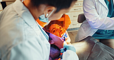 Buy stock photo Dentist, woman and consultation in clinic with equipment, medical procedure and filling tooth decay. Dental hygienist, patient and people in appointment with tools, oral assessment and healthcare.