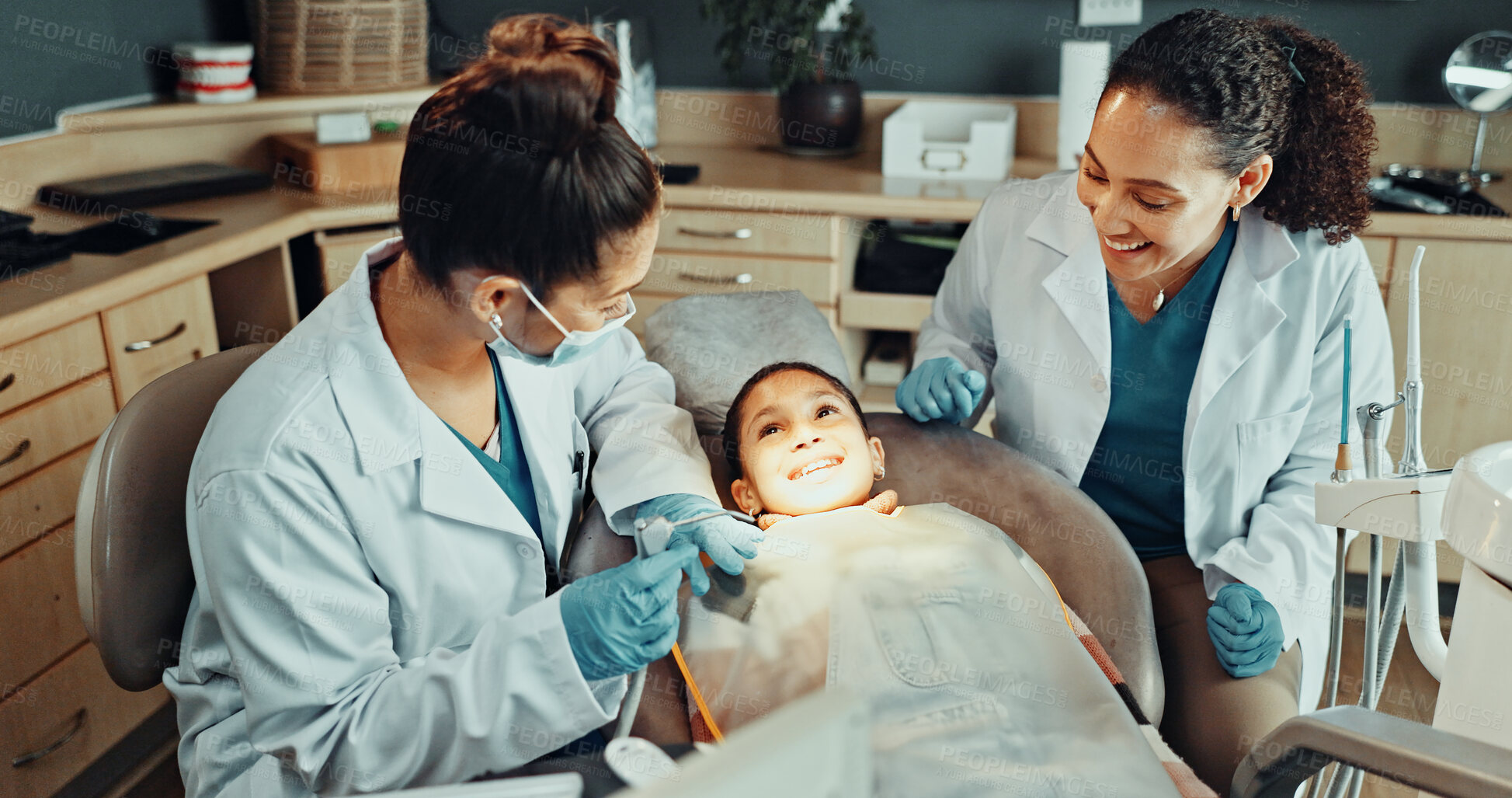 Buy stock photo Assistant, tools and dentist with kid in clinic for teeth cleaning, assessment or checkup. Oral hygiene, consultation and orthodontic team with girl child for tooth extraction for dental health.