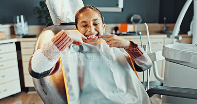 Buy stock photo Teeth, pointing and happy girl with dental hygiene in clinic for oral healthcare or treatment. Child, kid or big smile with gum care or satisfaction for dentist cleaning, exam or appointment on chair