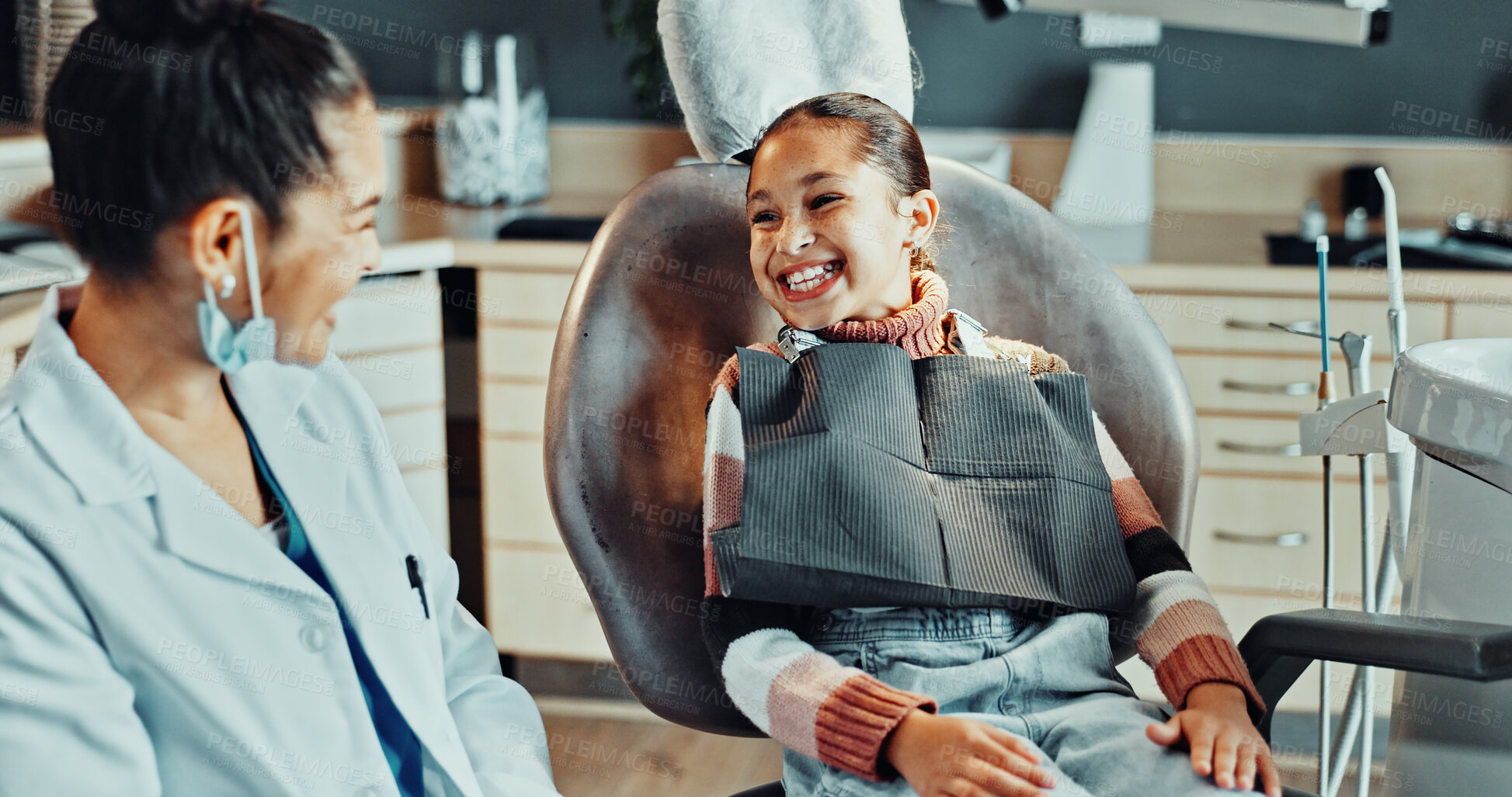 Buy stock photo Child, happy and dentist in practice for appointment, bravery and ready for dental procedure. Girl patient, orthodontist and teeth smile in office for consultation, gum wellness and treatment service