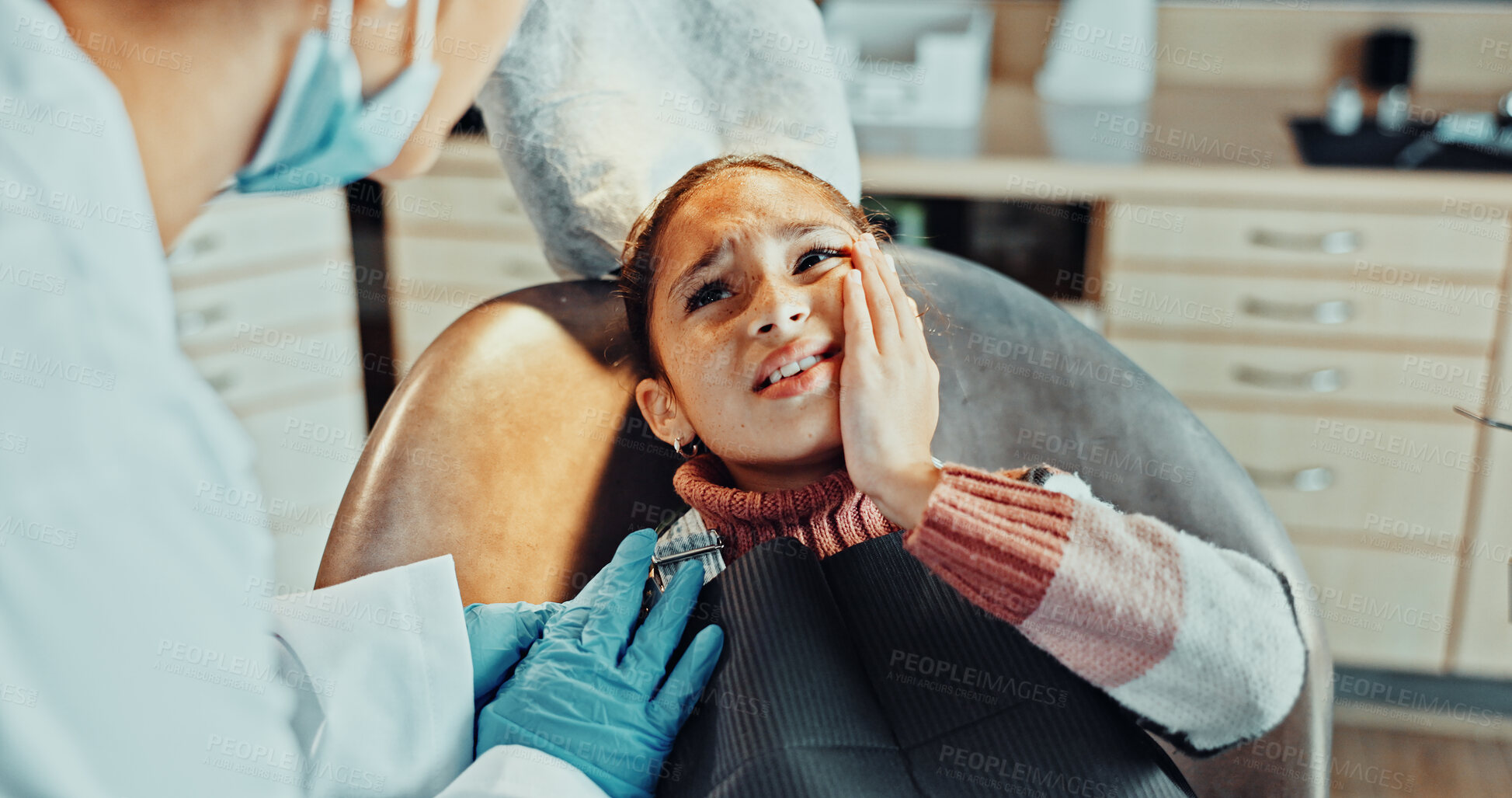 Buy stock photo Girl, patient and tooth pain with dentist in clinic for dental surgery or extraction appointment. Discomfort, child or kid with orthodontist, sore gum or toothache for gingivitis, cavity or decay