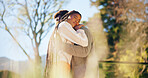 Couple, smile and hug at park, love and romance with partner on break and relax together in nature. Outdoor, embrace and happy with spouse, bonding and black people with connection on anniversary