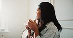 Thinking, woman and relax in home with coffee, start day and reflection for weekend unwind. Vision, female person and rest in lounge with beverage, nostalgia memory and comfortable for stress relief