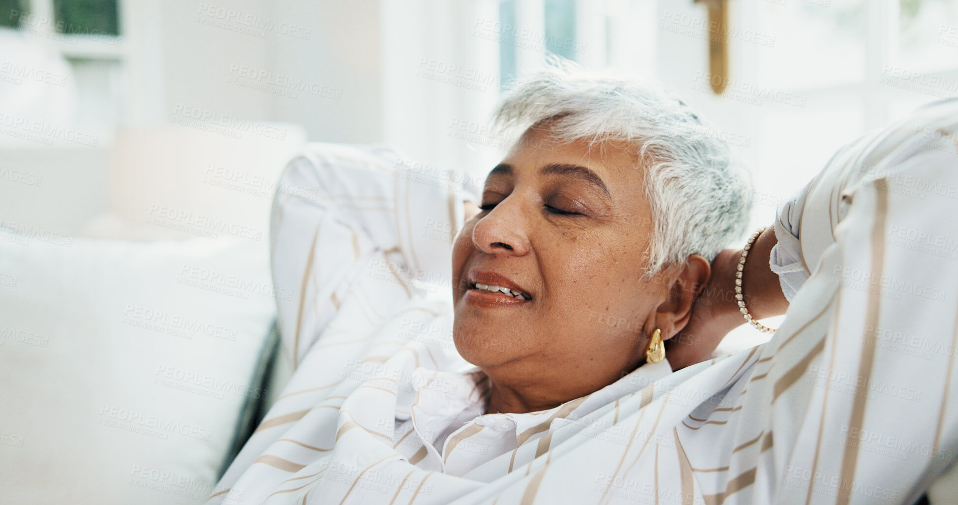 Buy stock photo Relax, peace and woman stretching on sofa for break, wellness and comfort with smile at home. Mature person, happy and resting on couch to chill in living room, calm or stress free for self care
