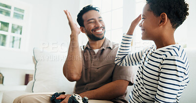 Buy stock photo High five, gaming and father and child in home for bonding, love and educational game together. Happy, celebration and dad with boy kid for entertainment on weekend in living room at apartment.