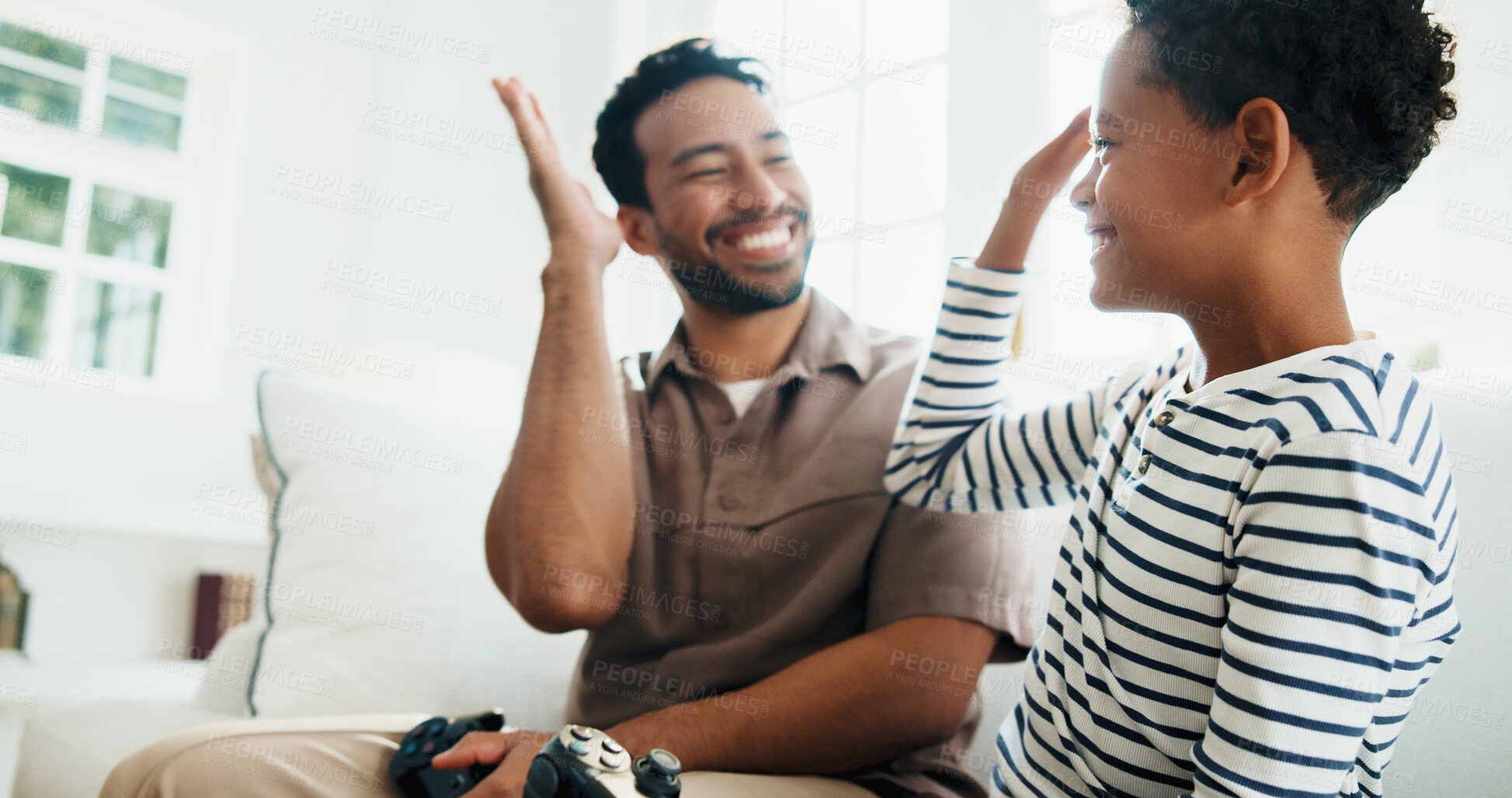 Buy stock photo High five, gaming and father and child in home for bonding, love and educational game together. Happy, celebration and dad with boy kid for entertainment on weekend in living room at apartment.