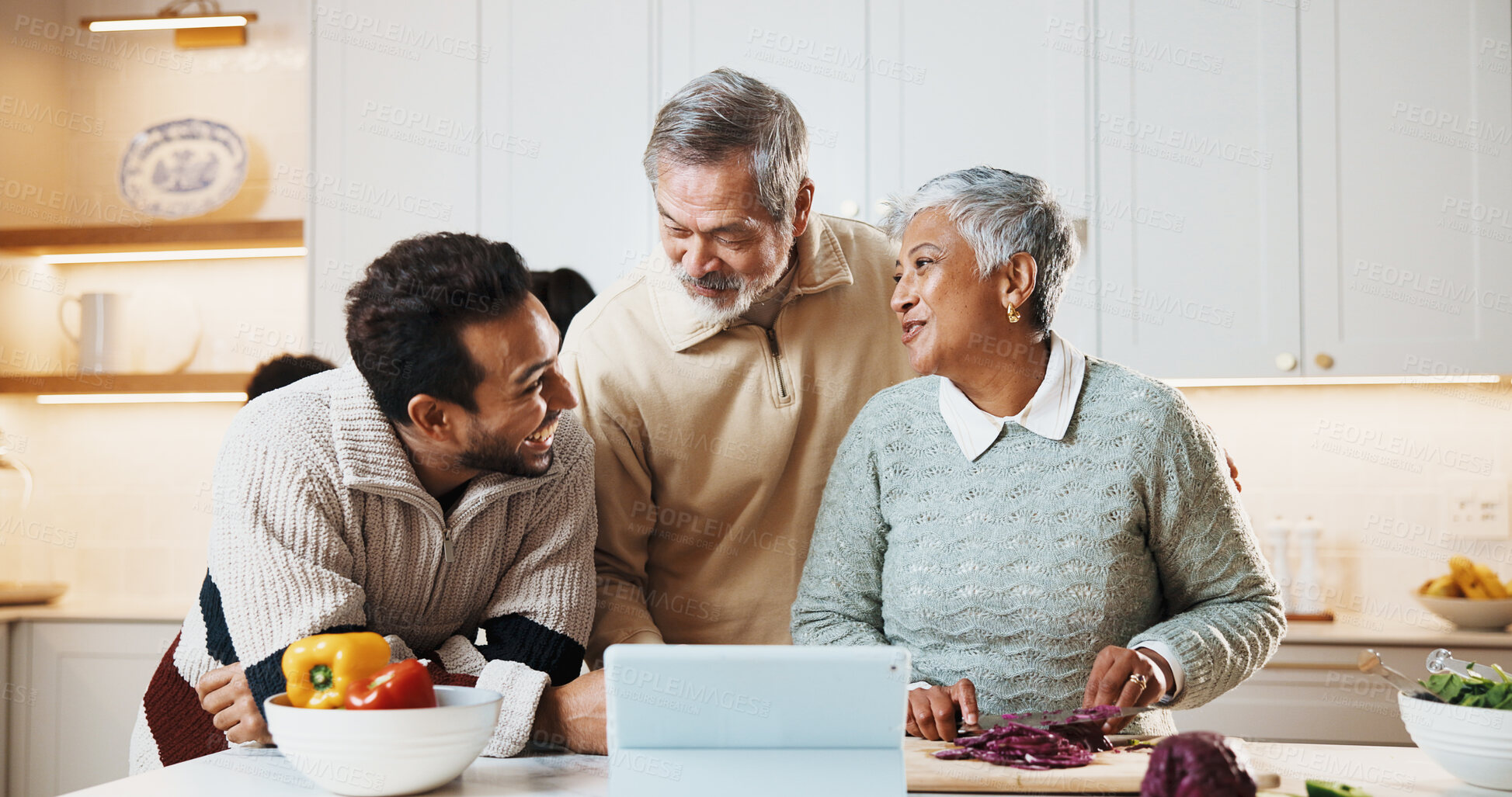 Buy stock photo Cooking, tablet and man with senior parents in kitchen at house for preparing meal together. Laugh, digital technology and adult son with elderly mom and dad for online recipe with nutrition dinner.
