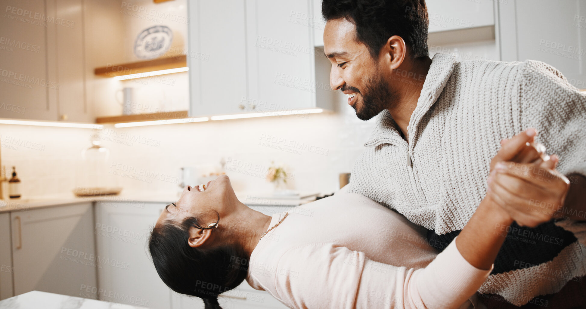 Buy stock photo Dancing, happy and couple in kitchen at house listening to music, playlist or radio together. Smile, love and man with woman for moving to song for bonding, care and connection in home on weekend.