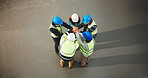 Construction, team and hands together in meeting or above for unity, solidarity or mission. Top view, architect or group of contractors piling with stack in huddle for social cohesion or inclusion