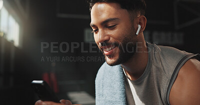 Buy stock photo Happy, man and phone in gym with earphones, browsing fitness app and listen to online music playlist. Person, smile or exercise recovery in health club with audio tech, social media or search workout