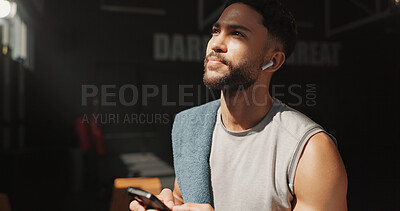 Buy stock photo Man, thinking and phone in gym with earphones, fitness and listen to music playlist for inspiration. Person, exercise break and reflection in health club with audio tech, radio or internet connection