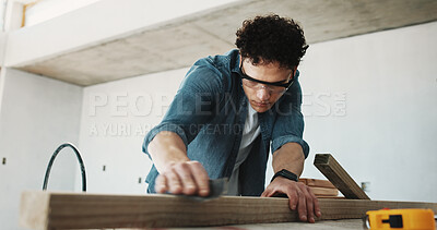 Buy stock photo Man, carpenter and sandpaper for construction with beam, restoration and furnishing for expansion. Male person, sanding and timber at site for carpentry, smooth surface and woodworking for renovation