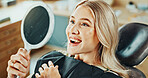 Woman, smile and dental care with mirror for oral hygiene, results and teeth whitening at dentist clinic. Happy, patient and healthcare at orthodontist for tooth cleaning, veneers and implants