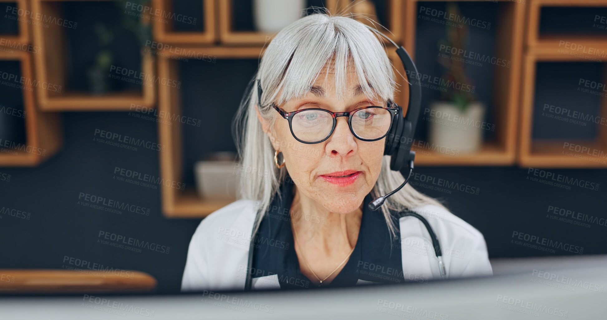 Buy stock photo Doctor, telehealth and woman with headset, video call and health services with computer in hospital. Healthcare, advice and mature person with tech, online and communication with contact in clinic
