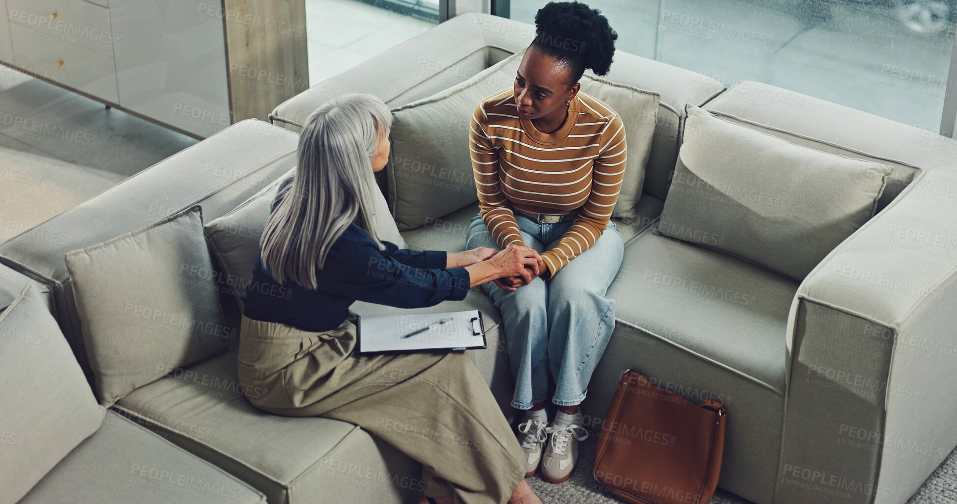 Buy stock photo Above, therapist and woman holding hands in office with empathy, wellness evaluation and counseling. Counselor, people and support in therapy with compassion, psychology and advice for mental health.