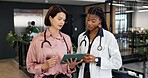 Doctor, team and reading at hospital with tablet, research and blood test results for diagnosis. Women, review and collaboration at clinic with digital, mri scan report and medical records for health