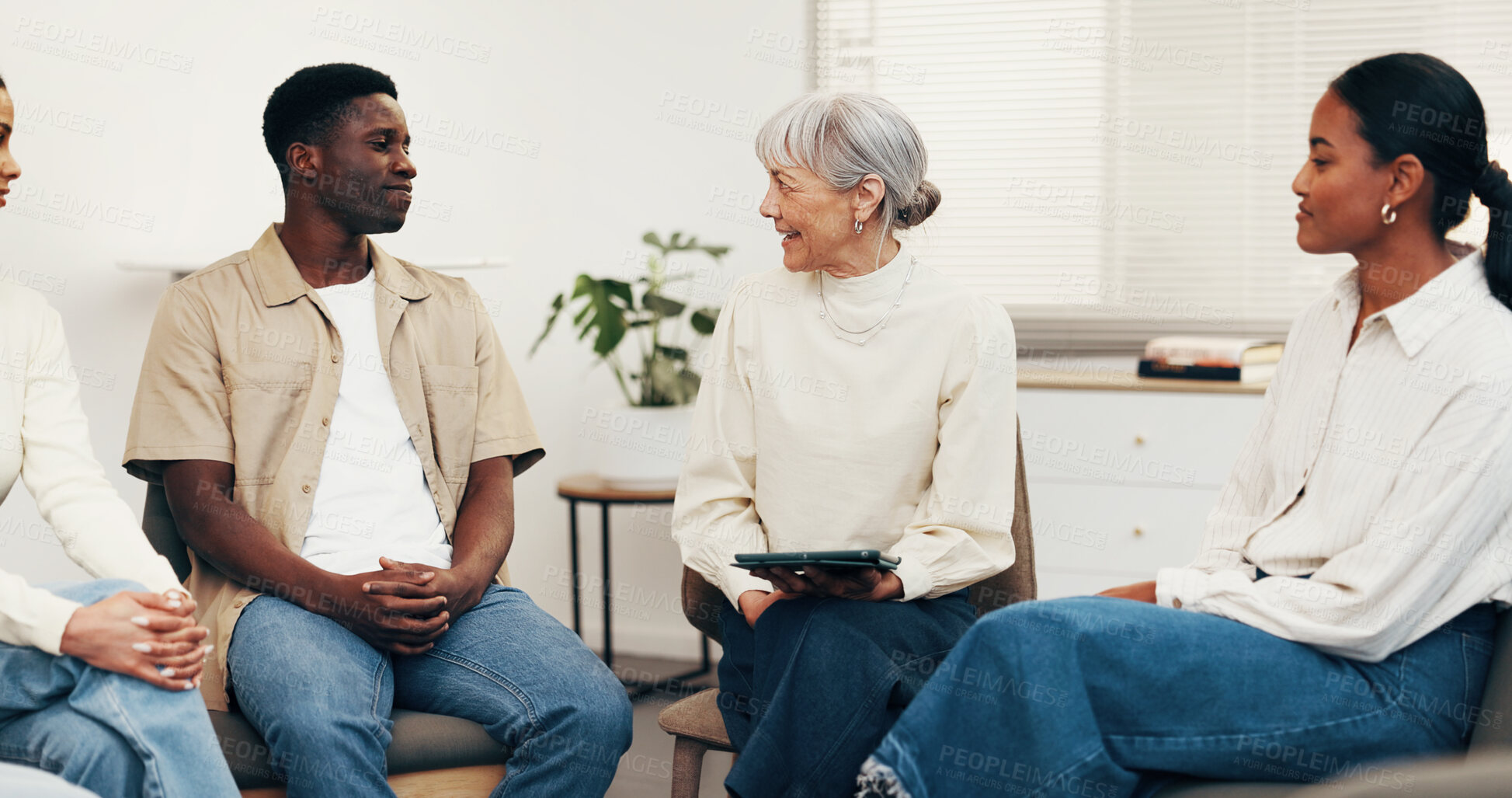 Buy stock photo Happy, therapist and talk with tablet for group therapy, coping mechanism and relapse prevention. Community center, people and mature counselor with tech for counseling, addiction recovery or support