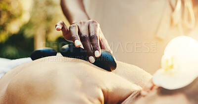 Buy stock photo Spa, woman and hands with hot stones for massage, stress relief and holistic treatment for healing. Hospitality, masseuse and person with heat therapy for pamper, self care and relax for zen wellness