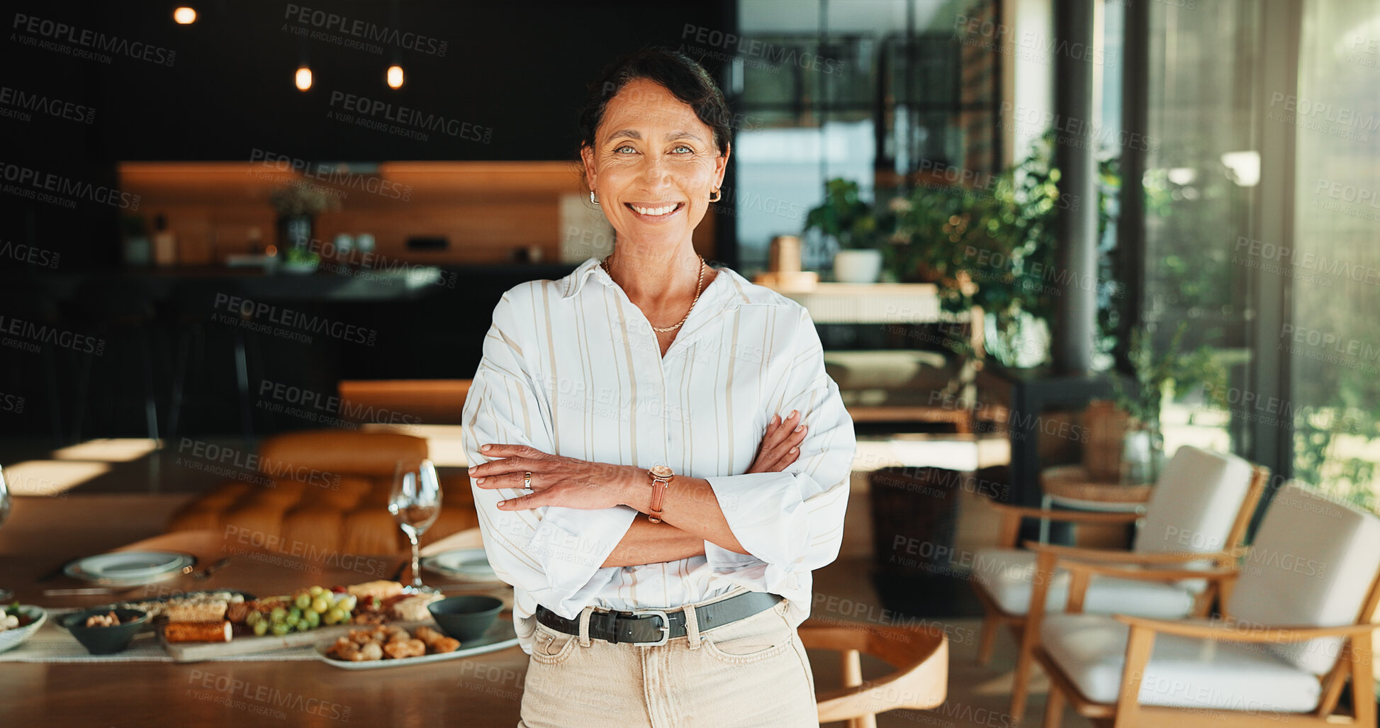 Buy stock photo Host, portrait or woman in lounge with arms crossed, happy moment or confidence with party planning. Wellness, smile or mature person in home with meal, satisfaction or optimism in dinner preparation